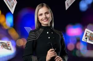 Smiling woman with blonde hair and playing cards