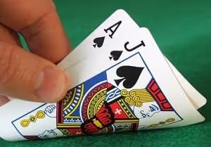 Hand holding a Blackjack hand: Ace of Spades and Jack of Spades