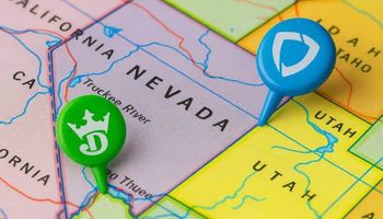 A close-up of a U.S. map focused on Nevada with two removed push pins in green and blue, symbolizing DraftKings and FanDuel withdrawing from the state’s sports betting market.