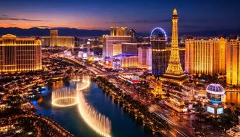 Las Vegas Strip skyline at dusk with casino resorts and traffic along the Strip.