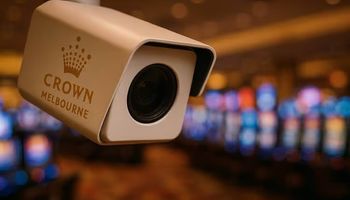 Close-up of a Crown Melbourne security camera overlooking a blurred casino gaming floor.