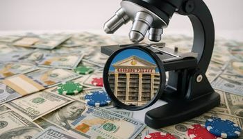 Image of a microscope inspecting Caesars Palace with cash and casino chips spread across a white desk, symbolizing an AML investigation.