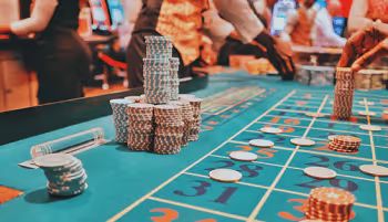 Roulette table with chips and players