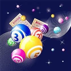 Colorful bingo balls and cards on a dark background with sparkles
