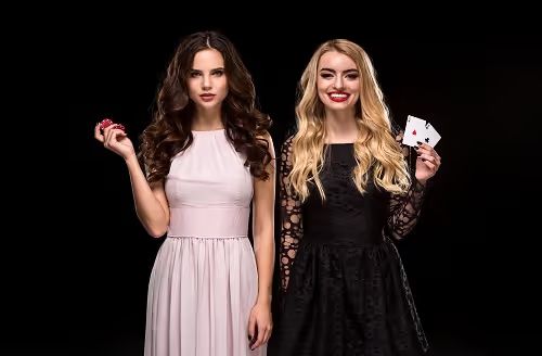 two sexy girls brunette blonde posing with chips her hands poker concept black background 1