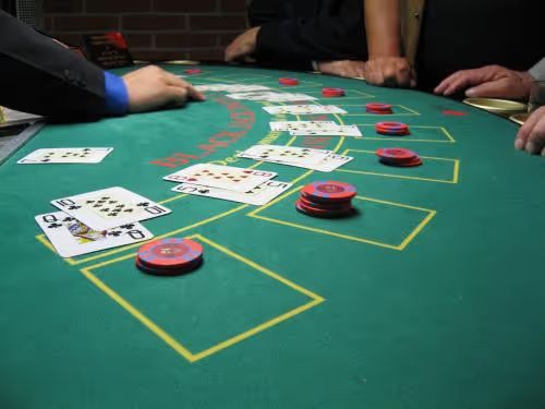 Blackjack game in progress on a green table