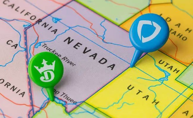 A close-up of a U.S. map focused on Nevada with two removed push pins in green and blue, symbolizing DraftKings and FanDuel withdrawing from the state’s sports betting market.