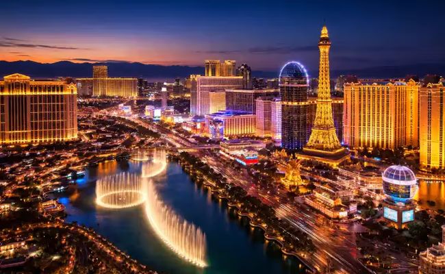 Las Vegas Strip skyline at dusk with casino resorts and traffic along the Strip.