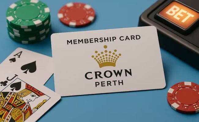 A Crown Perth membership card placed on a light blue surface with casino chips, blackjack cards, and a slot machine bet button.